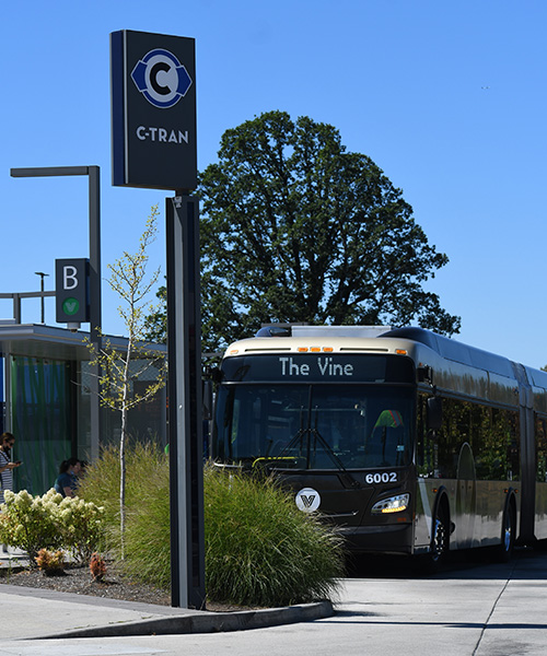 The front of a Vine bus on a sunny day at Vancouver Mall Transit Center.